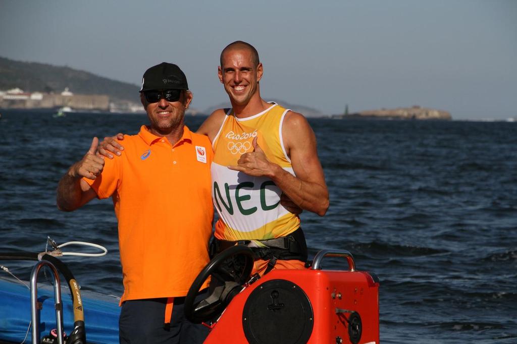 New Zealand coach Aaron Macintosh and windsurfer, Dorian van Rijsselberghe (NED) celebrate winning a second Olympic Gold Medal on day 7 of the 2016 Rio Olympic Regatta © Richard Gladwell www.photosport.co.nz